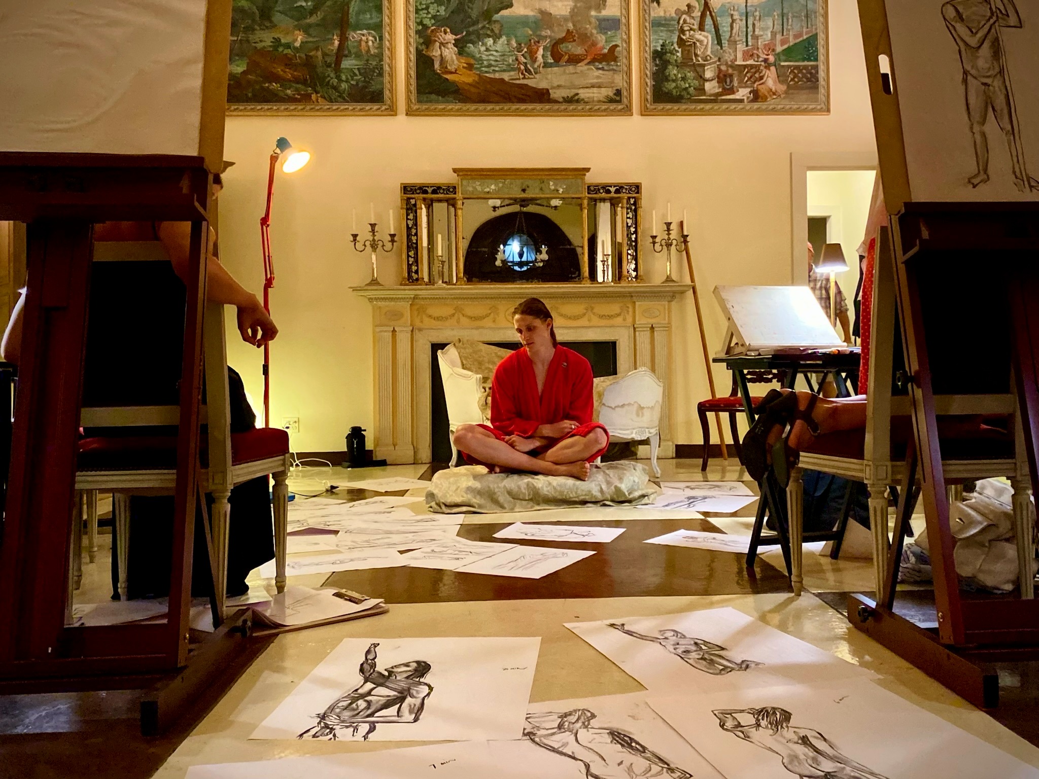 A Brantwood Atelier session with drawings spread across the floor in front of a seated model.